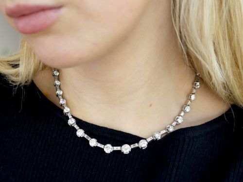 fig 3. An antique Art Deco platinum necklace set with alternating round cut and baguette cut diamonds linked in a continuous line.