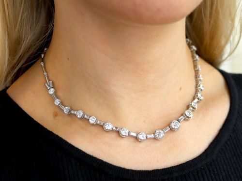 fig 4. An antique Art Deco platinum necklace set with alternating round cut and baguette cut diamonds linked in a continuous line.