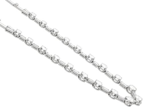 fig 7. An antique Art Deco platinum necklace set with alternating round cut and baguette cut diamonds linked in a continuous line.