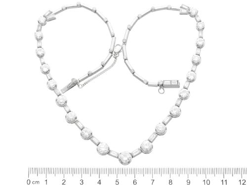 fig 9. An antique Art Deco platinum necklace set with alternating round cut and baguette cut diamonds linked in a continuous line.
