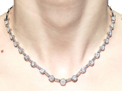 fig 10. An antique Art Deco platinum necklace set with alternating round cut and baguette cut diamonds linked in a continuous line.