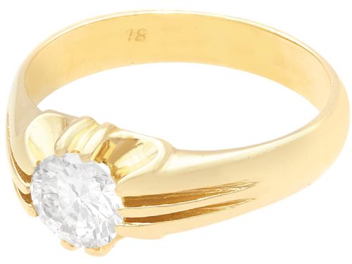 fig 5. An 18ct yellow gold solitaire ring featuring a round central diamond held in a claw setting with fluted shoulders.