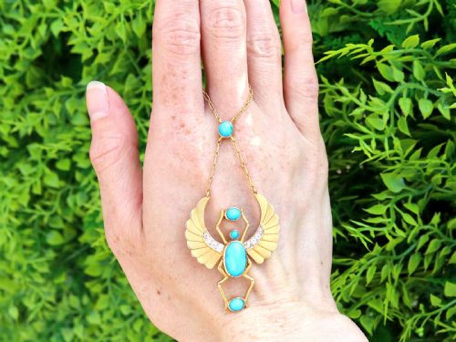 fig 1. An 18ct yellow gold Egyptian Revival pendant crafted in the shape of a winged scarab beetle with turquoise cabochons and set with diamonds.