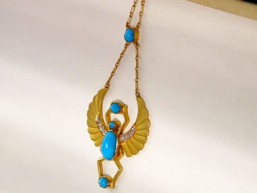 fig 2. An 18ct yellow gold Egyptian Revival pendant crafted in the shape of a winged scarab beetle with turquoise cabochons and set with diamonds.