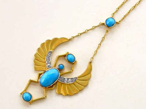 fig 3. An 18ct yellow gold Egyptian Revival pendant crafted in the shape of a winged scarab beetle with turquoise cabochons and set with diamonds.