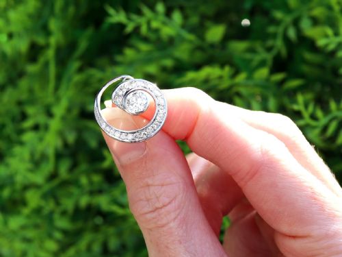 fig 1. A pair of 14ct white gold twirl earrings featuring round brilliant cut diamonds set in a concentric spiral design around a central diamond.
