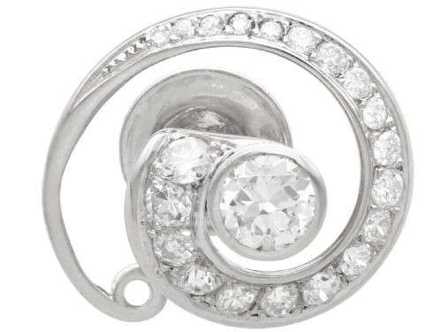fig 3. A pair of 14ct white gold twirl earrings featuring round brilliant cut diamonds set in a concentric spiral design around a central diamond.