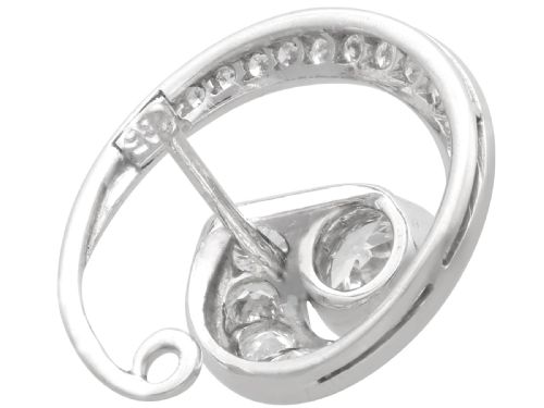 fig 4. A pair of 14ct white gold twirl earrings featuring round brilliant cut diamonds set in a concentric spiral design around a central diamond.