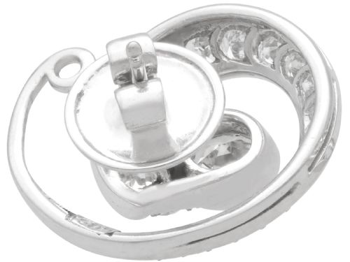 fig 5. A pair of 14ct white gold twirl earrings featuring round brilliant cut diamonds set in a concentric spiral design around a central diamond.