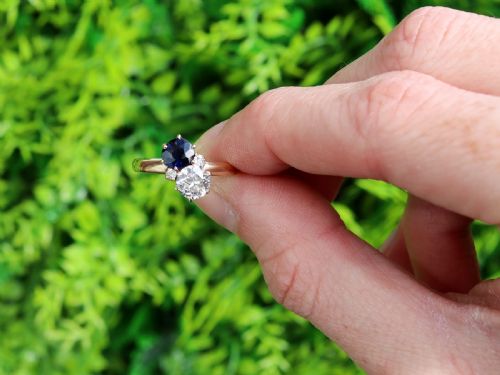 fig 1. An antique 14ct yellow gold ring featuring an oval blue sapphire paired with a round diamond and small accent stones in claw settings.