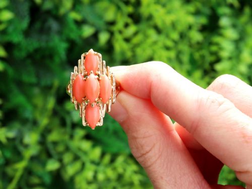 fig 1. A 1960s 14ct yellow gold cocktail ring featuring five marquise cabochon corals set within a textured abstract gold framework.