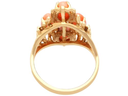 fig 6. A 1960s 14ct yellow gold cocktail ring featuring five marquise cabochon corals set within a textured abstract gold framework.