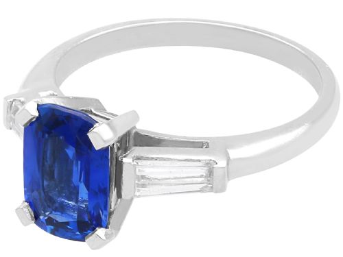 fig 3. An Art Deco platinum ring featuring a central cushion-cut blue sapphire flanked by a stepped baguette-cut diamond on each shoulder.
