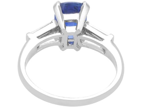 fig 4. An Art Deco platinum ring featuring a central cushion-cut blue sapphire flanked by a stepped baguette-cut diamond on each shoulder.