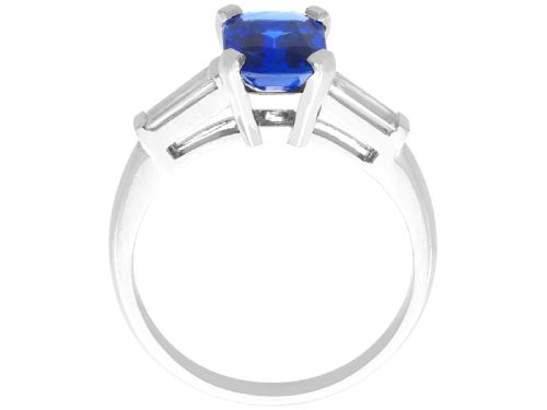 fig 5. An Art Deco platinum ring featuring a central cushion-cut blue sapphire flanked by a stepped baguette-cut diamond on each shoulder.