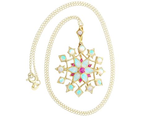 fig 4. An antique 15ct yellow gold starburst pendant brooch set with cabochon opals and faceted rubies suspended on a gold chain.