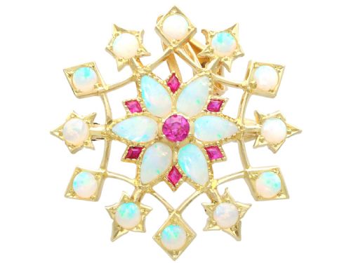 fig 5. An antique 15ct yellow gold starburst pendant brooch set with cabochon opals and faceted rubies suspended on a gold chain.