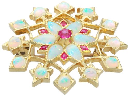 fig 6. An antique 15ct yellow gold starburst pendant brooch set with cabochon opals and faceted rubies suspended on a gold chain.
