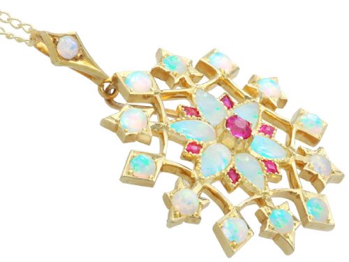 fig 7. An antique 15ct yellow gold starburst pendant brooch set with cabochon opals and faceted rubies suspended on a gold chain.