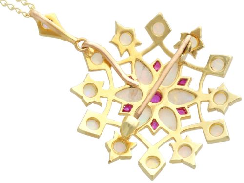 fig 8. An antique 15ct yellow gold starburst pendant brooch set with cabochon opals and faceted rubies suspended on a gold chain.