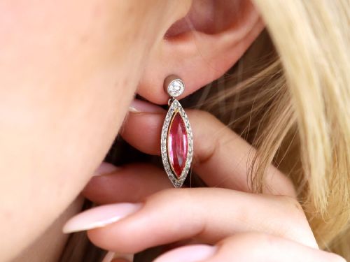 fig 2. Pair of Art Deco platinum drop earrings featuring navette-cut pink tourmalines bordered by small diamonds, suspended from round diamond studs.