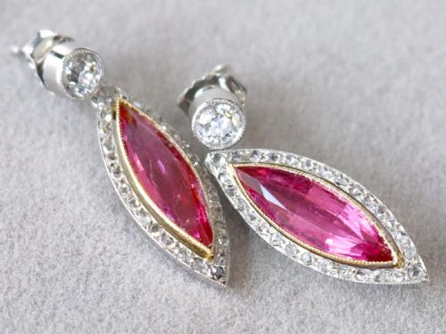 fig 3. Pair of Art Deco platinum drop earrings featuring navette-cut pink tourmalines bordered by small diamonds, suspended from round diamond studs.