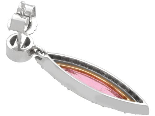 fig 5. Pair of Art Deco platinum drop earrings featuring navette-cut pink tourmalines bordered by small diamonds, suspended from round diamond studs.
