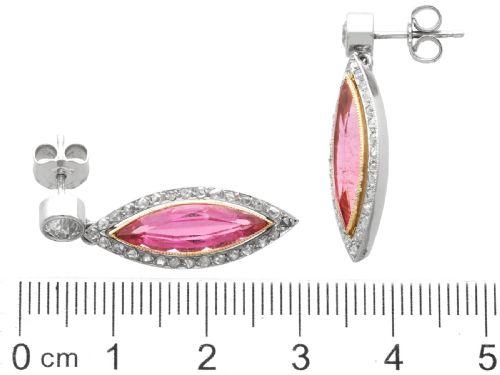 fig 7. Pair of Art Deco platinum drop earrings featuring navette-cut pink tourmalines bordered by small diamonds, suspended from round diamond studs.