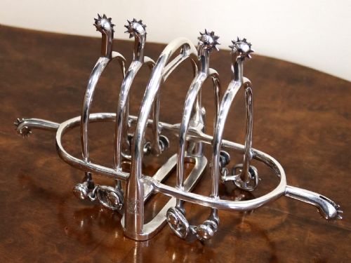fig 2. An antique sterling silver toast rack designed with equestrian riding spurs and rowels.