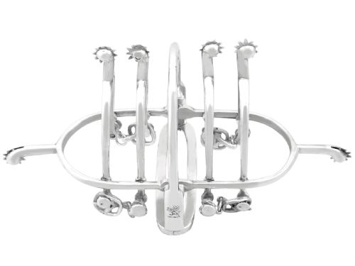 fig 3. An antique sterling silver toast rack designed with equestrian riding spurs and rowels.