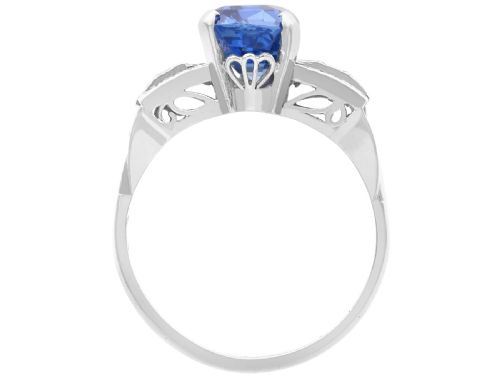 fig 5. An Art Deco platinum cocktail ring featuring a large cushion-cut blue Ceylon sapphire held in four prongs between geometric diamond-set shoulders.