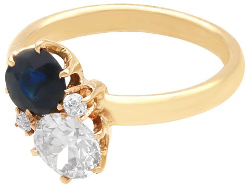 fig 4. An antique 14ct yellow gold ring featuring an oval blue sapphire paired with a round diamond and small accent stones in claw settings.