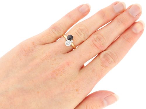 fig 7. An antique 14ct yellow gold ring featuring an oval blue sapphire paired with a round diamond and small accent stones in claw settings.