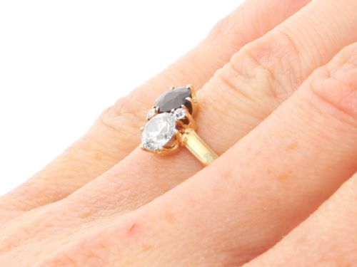 fig 8. An antique 14ct yellow gold ring featuring an oval blue sapphire paired with a round diamond and small accent stones in claw settings.
