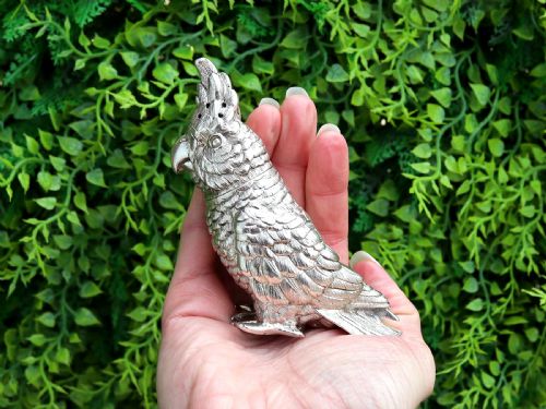 fig 1. A Victorian sterling silver pepperette cast in the detailed likeness of a cockatoo with pierced holes along its crest.