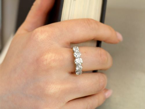 fig 3. An 18ct yellow gold and platinum ring featuring five claw-set round diamonds arranged horizontally in a row.