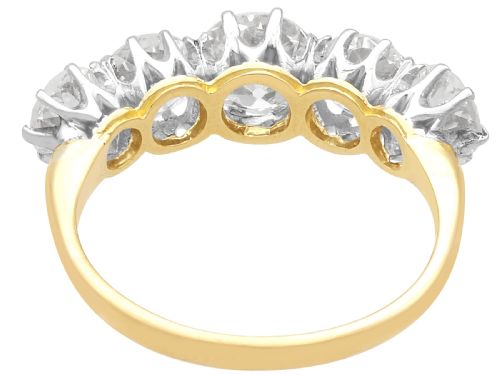 fig 5. An 18ct yellow gold and platinum ring featuring five claw-set round diamonds arranged horizontally in a row.