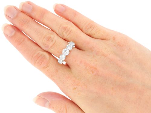fig 7. An 18ct yellow gold and platinum ring featuring five claw-set round diamonds arranged horizontally in a row.