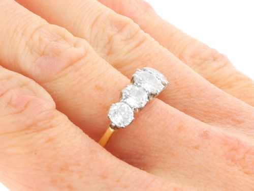 fig 8. An 18ct yellow gold and platinum ring featuring five claw-set round diamonds arranged horizontally in a row.