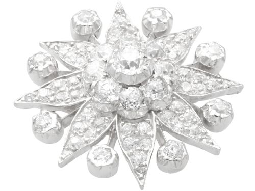 fig 4. An antique Edwardian silver-topped diamond star brooch featuring a central round diamond surrounded by diamond-paved star rays and ball terminals.