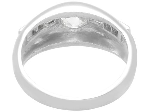fig 2. A vintage platinum ring featuring a centre round brilliant diamond flanked by baguette and round cut diamonds set into a broad band.