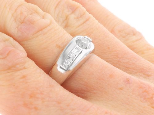 fig 5. A vintage platinum ring featuring a centre round brilliant diamond flanked by baguette and round cut diamonds set into a broad band.