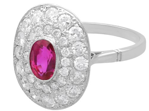 fig 5. An 18ct white gold halo ring featuring a central oval red ruby surrounded by two tiers of round diamonds.