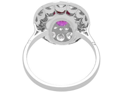 fig 6. An 18ct white gold halo ring featuring a central oval red ruby surrounded by two tiers of round diamonds.