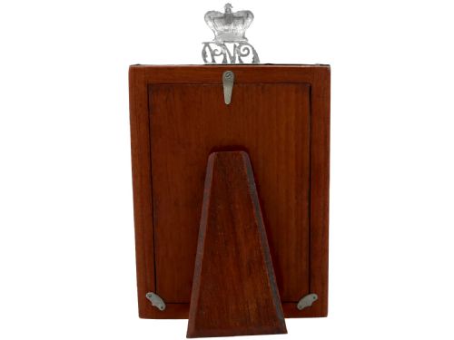 fig 4. A rectangular sterling silver picture frame featuring an oval aperture, topped with a royal crown monogram and detailed with a laurel wreath emblem at the base.