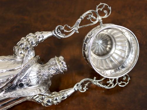 fig 4. A Victorian sterling silver wager cup depicting a bearded male figure holding a double-handled vessel above his head.