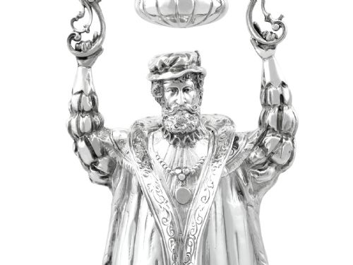 fig 9. A Victorian sterling silver wager cup depicting a bearded male figure holding a double-handled vessel above his head.