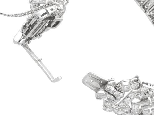 fig 9. An Art Deco platinum bracelet set with a central marquise diamond and surrounding geometric rows of baguette and round diamonds.