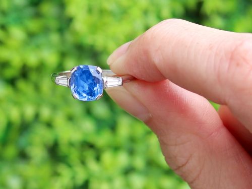 fig 1. An Art Deco platinum ring featuring a cushion-cut blue sapphire flanked by two tapered baguette diamonds.
