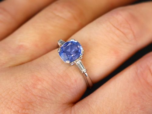 fig 2. An Art Deco platinum ring featuring a cushion-cut blue sapphire flanked by two tapered baguette diamonds.